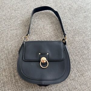 Bagley Mischka Timeless Black and Gold Leather Shoulder Bag with Saddle Design